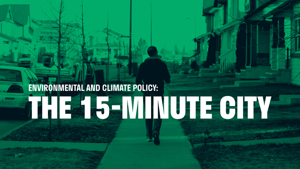 An image of Amarjeet Sohi walking through an Edmonton neighbourhood. The text overlay reads "Environment and Climate Policy: the 15-minute city"